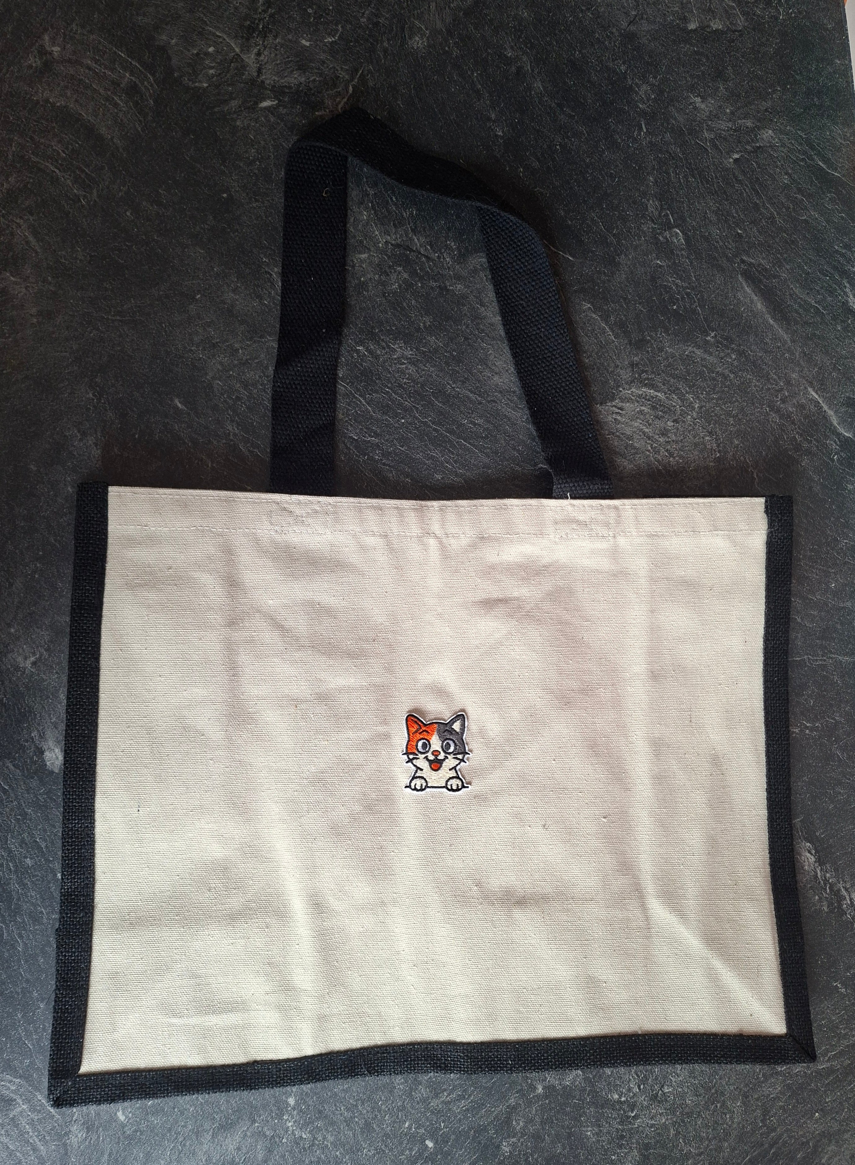 The "Purr-veillance State" jute tote