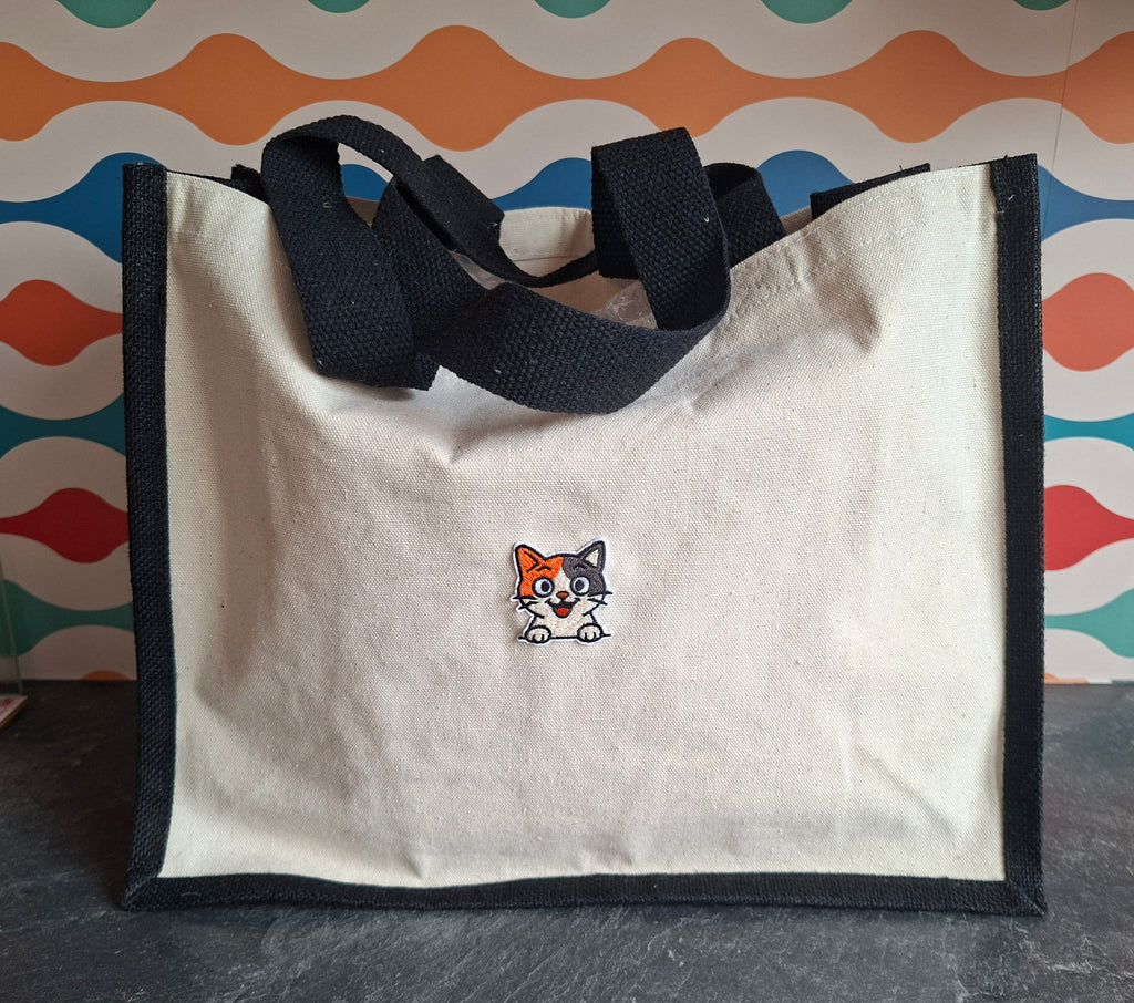 The "Purr-veillance State" jute tote