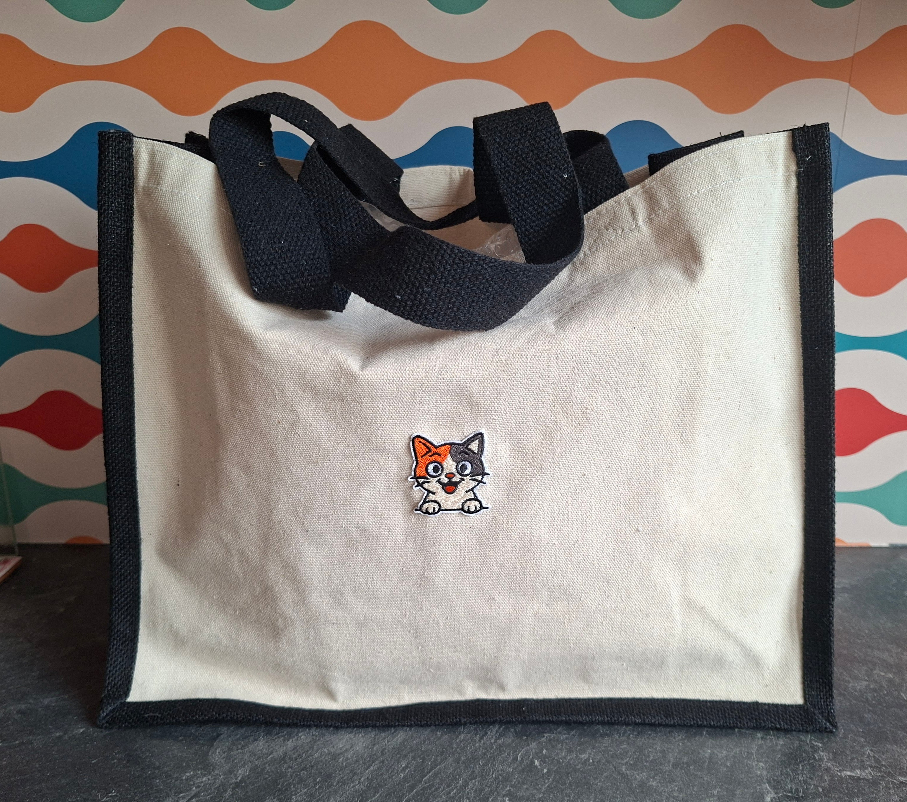 The "Purr-veillance State" jute tote